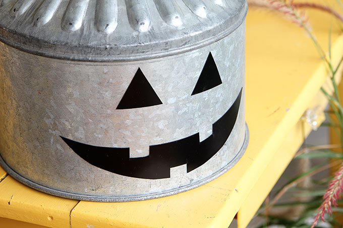 A super cute repurposed Jack-o-Lantern for Halloween made from a galvanized funnel. A quick and easy DIY project for fall!