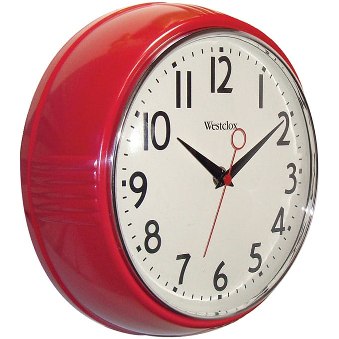 Red retro style school clock that hangs on the wall.