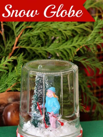 Learn how to make a super cute DIY snow globe from a jelly jar. A quick, easy and inexpensive holiday craft project the kids can help with.