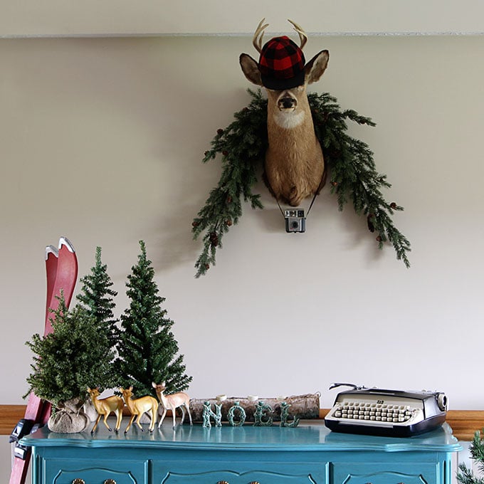 A fun and sassy vintage eclectic holiday home complete with a few kitschy blow molds, a small herd of plastic deer and plaid thermoses galore.