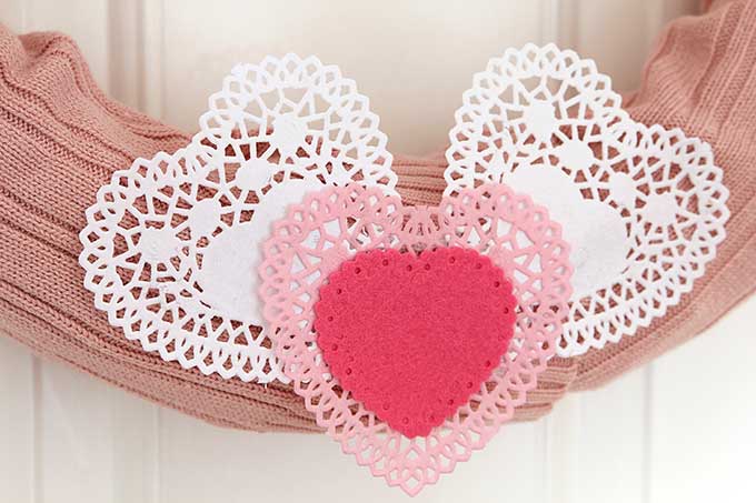 Learn how to make this quick and easy sweater wreath for Valentine's Day. Great way to upcycle your thrift store find. 