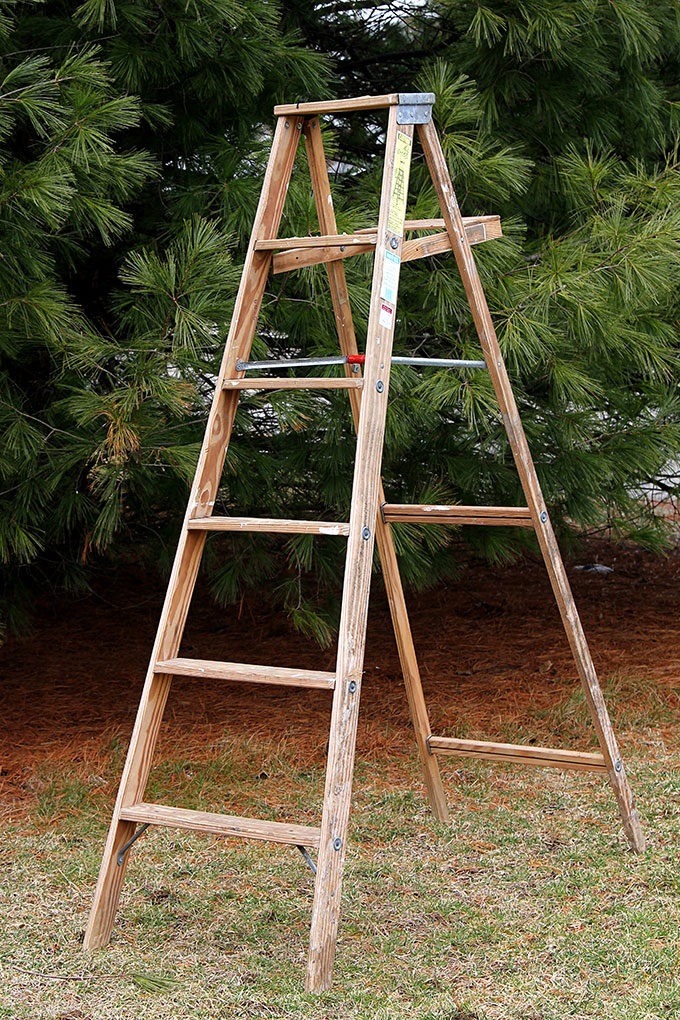 Use a wooden ladder as garden art in the flower beds this summer. They add much needed height to the garden and a place to display bird houses and planters.