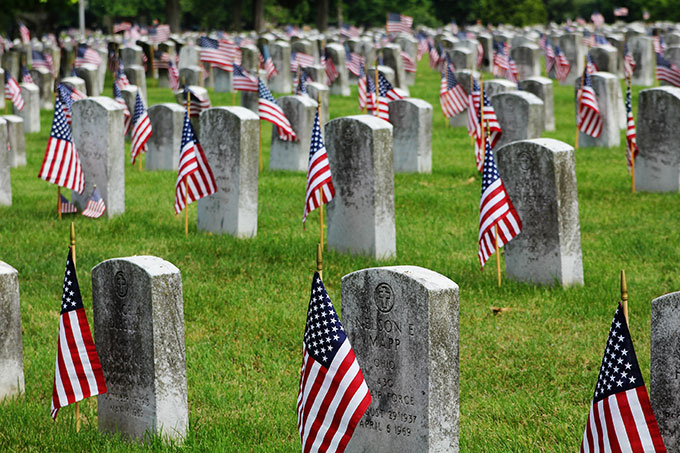 Flags at the cemetery for Memorial Day along with a quote.