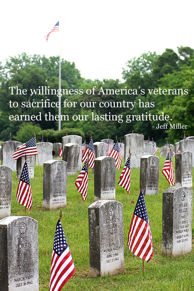 Flags at the cemetery for Memorial Day along with a quote.