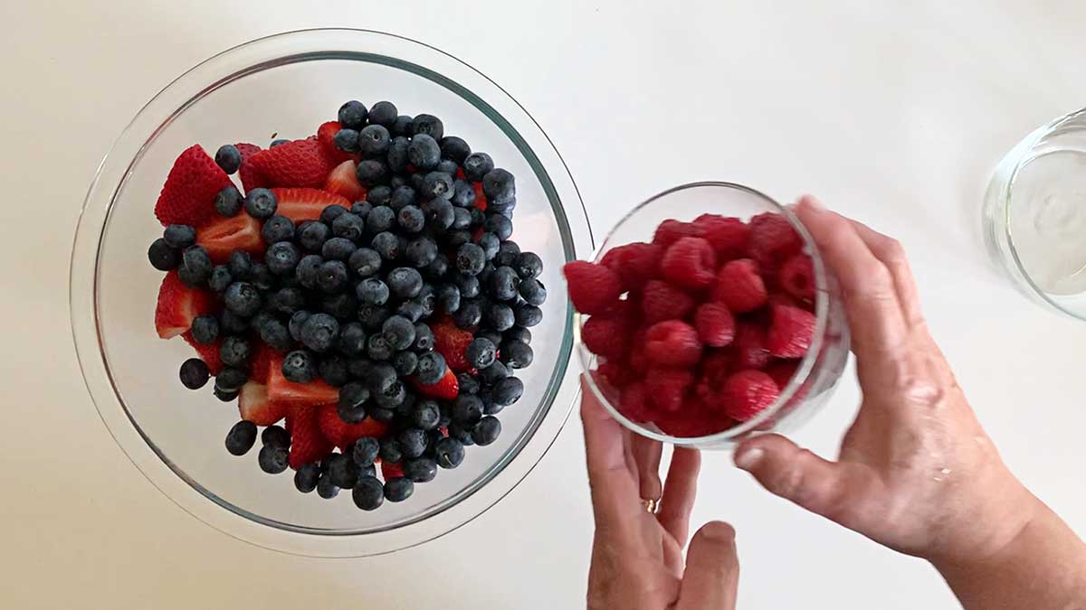 Mixing berries for berry fruit salad.