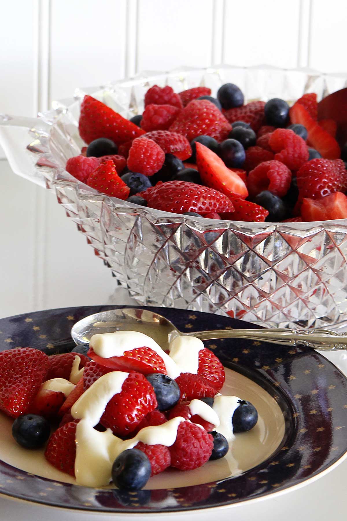 Mixed berry fruit salad recipe on a plate with honey citrus dressing.
