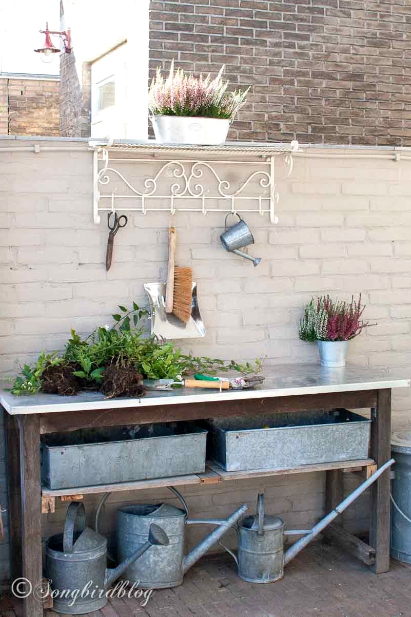 Upcycled potting bench made from outdoor dining table.