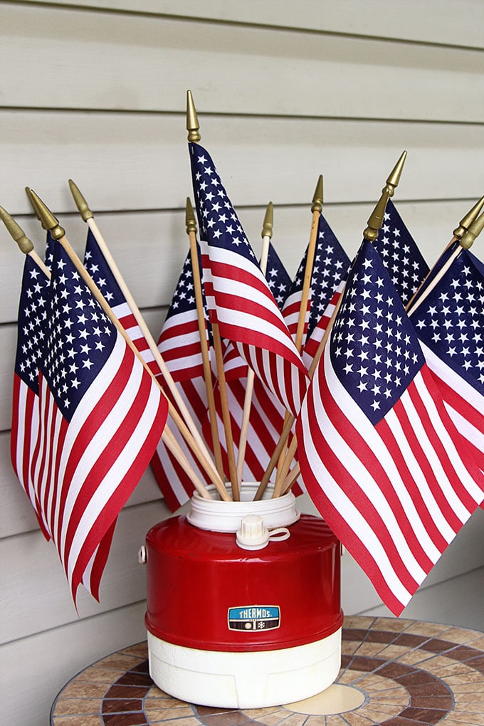 Flags in a vintage red thermos for the 4th of July