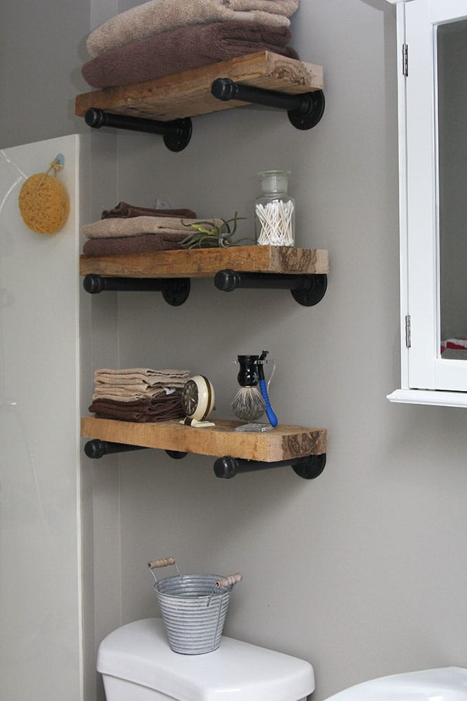 Styled bathroom pipe shelves
