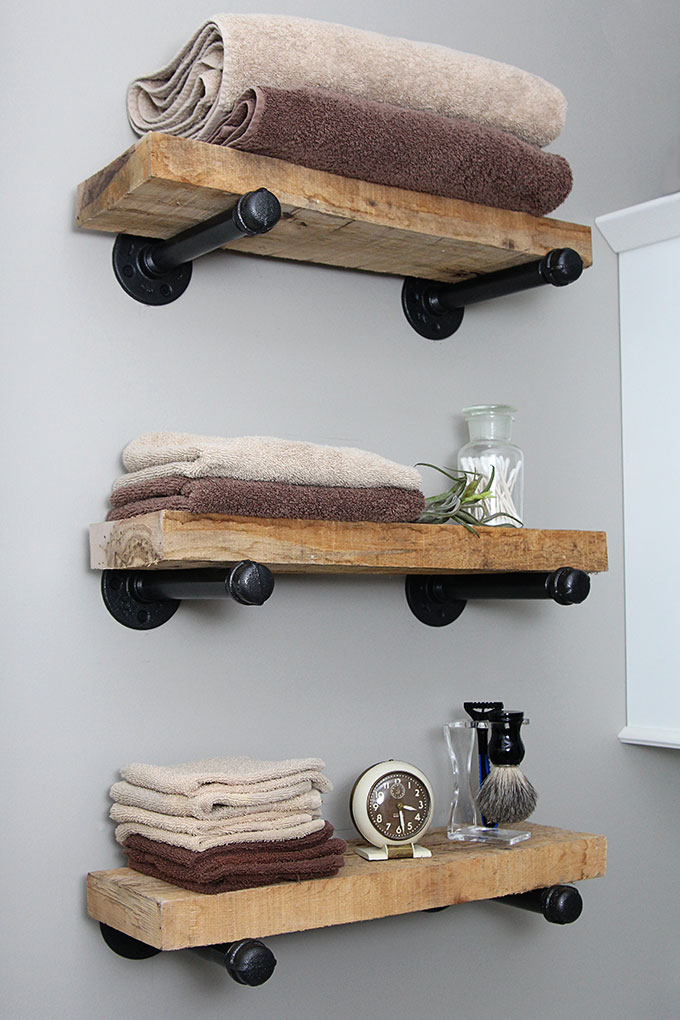 3 pipe shelves topped with thick wood in a bathroom