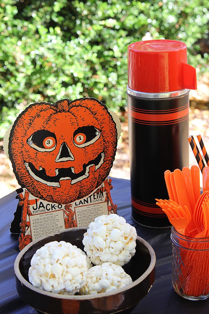 Beistle Halloween Game at a traditional Halloween party with orange and black decor including blow molds and vintage inspired Halloween decorations.