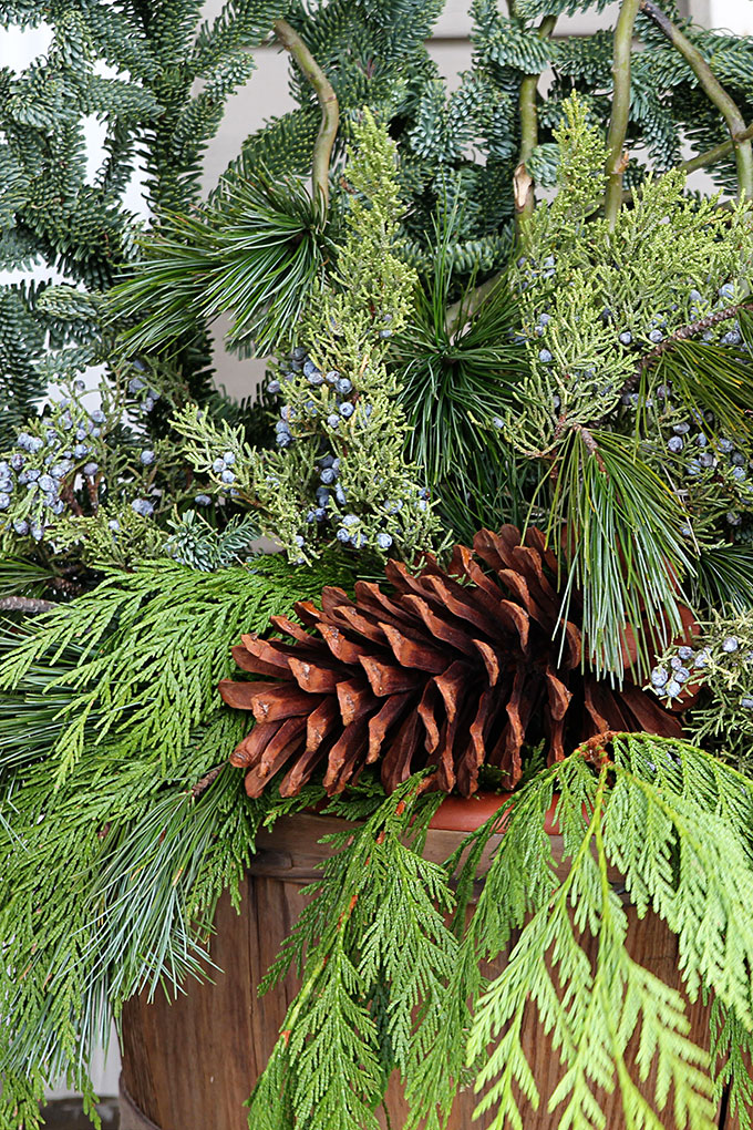 Festive Christmas porch decorations that transition easily from Christmas to winter are found on our rustic, farmhouse, plaid and nature inspired porch.