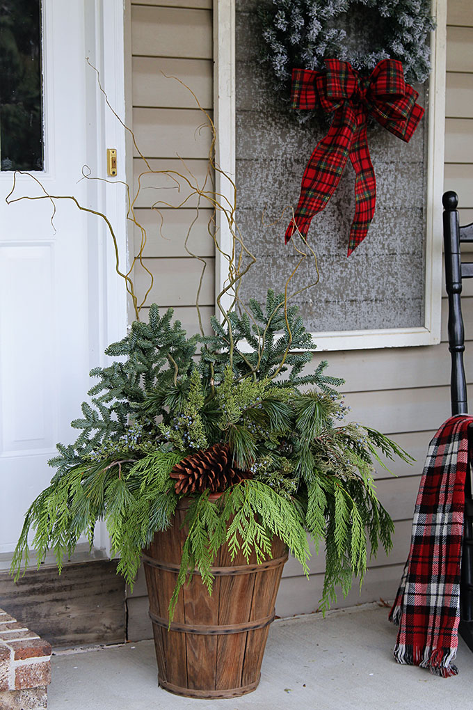 Festive Christmas porch decorations that transition easily from Christmas to winter are found on our rustic, farmhouse, plaid and nature inspired porch.