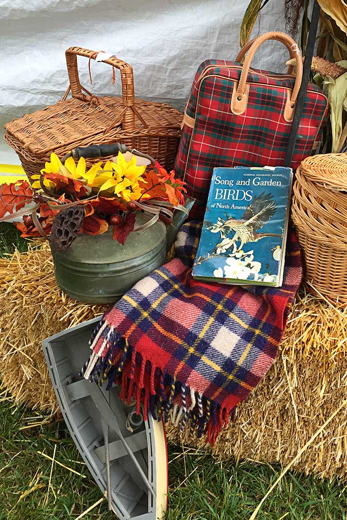 Fall decor at the Country Living Fair including plaid throws and thermoses.