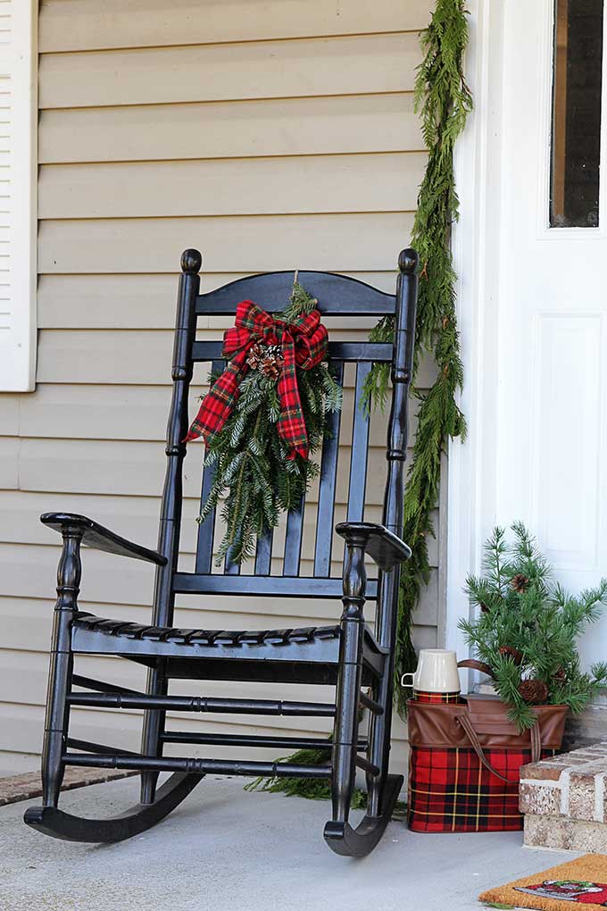 Traditional black porch rocker on a Christmas porch