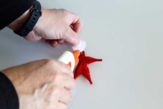 Gluing head to pipe cleaner ornament