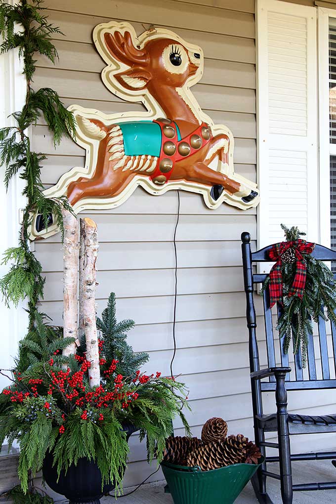 Vintage store display reindeer used as front porch Christmas decorations