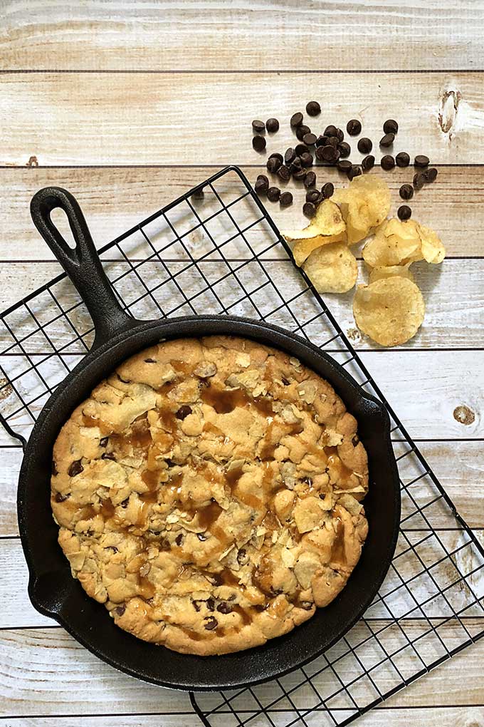 Sweet and salty potato chip and chocolate chip cookie made in a cast iron skillet. The perfect combination of salty and sweet with a little bit of crunch make this quick and easy cookie recipe a winner at our house! #dessertrecipes #cookie