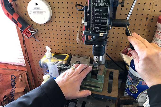 Using drill press to drill hole into silverware