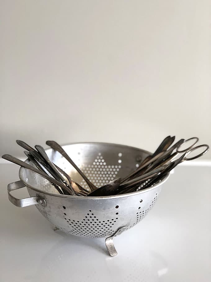 Colander and silverware to make wind chimes