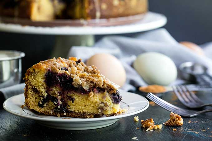 Slice of blueberry coffee cake with crumb topping