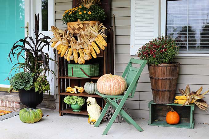 Front porch fall decor with a harvest theme.