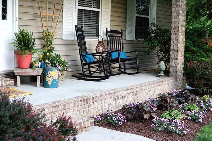 Black porch rockers on a summer porch