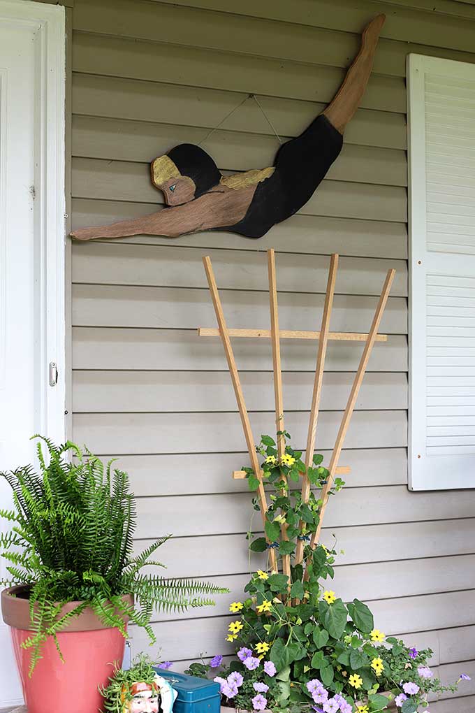 Wooden cutout of diving girl used as summer porch decor