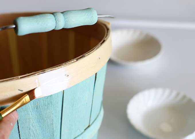 Painting wooden bushel basket.