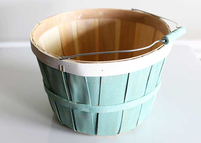 Wooden bushel basket repurposed into planter.