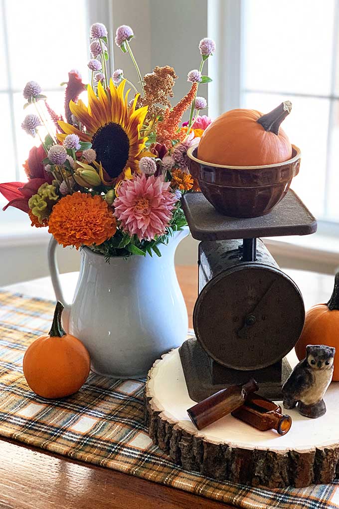 rustic table centerpiece using vintage scale and fall bouquet