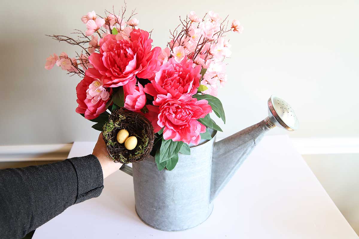 spring flower arrangement in watering can