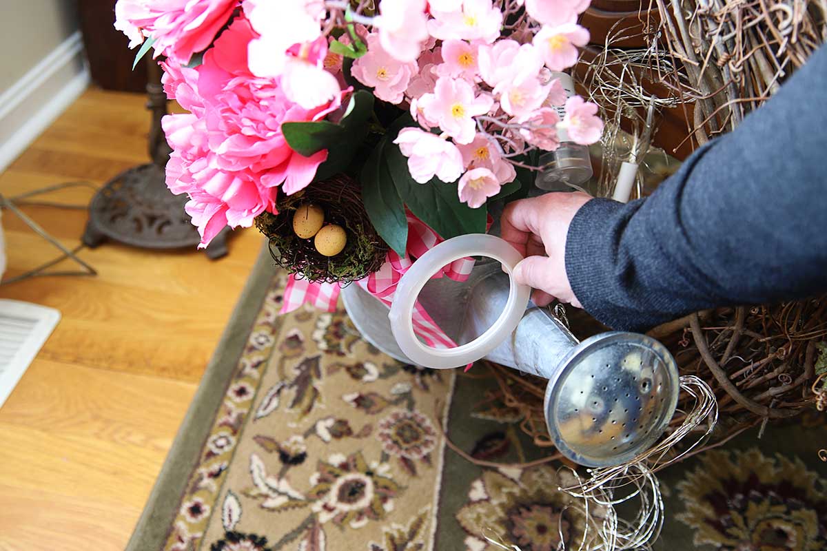 attaching fairy lights to watering can