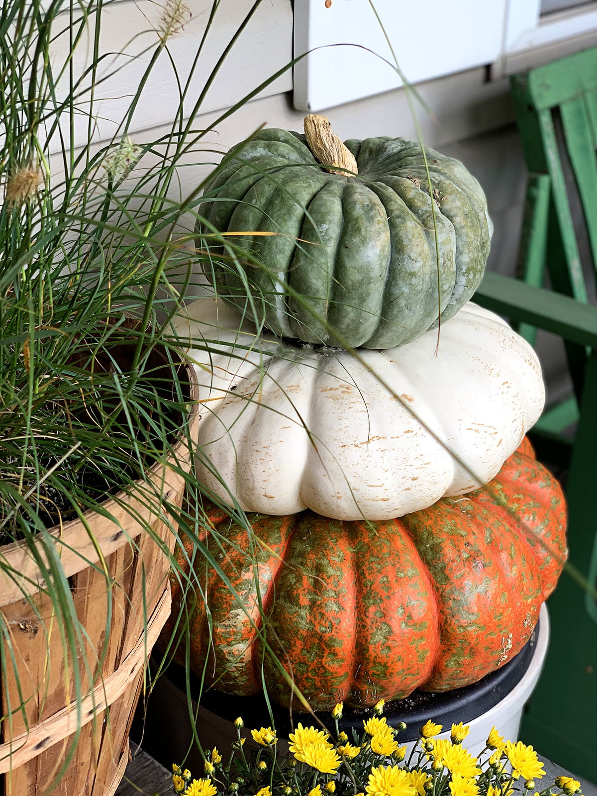 Pumpkins stacked on top of each other as fall decor.