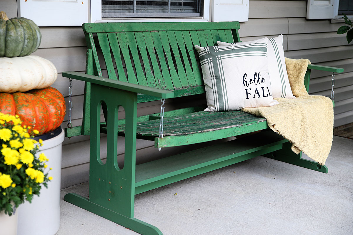 wooden green porch swing