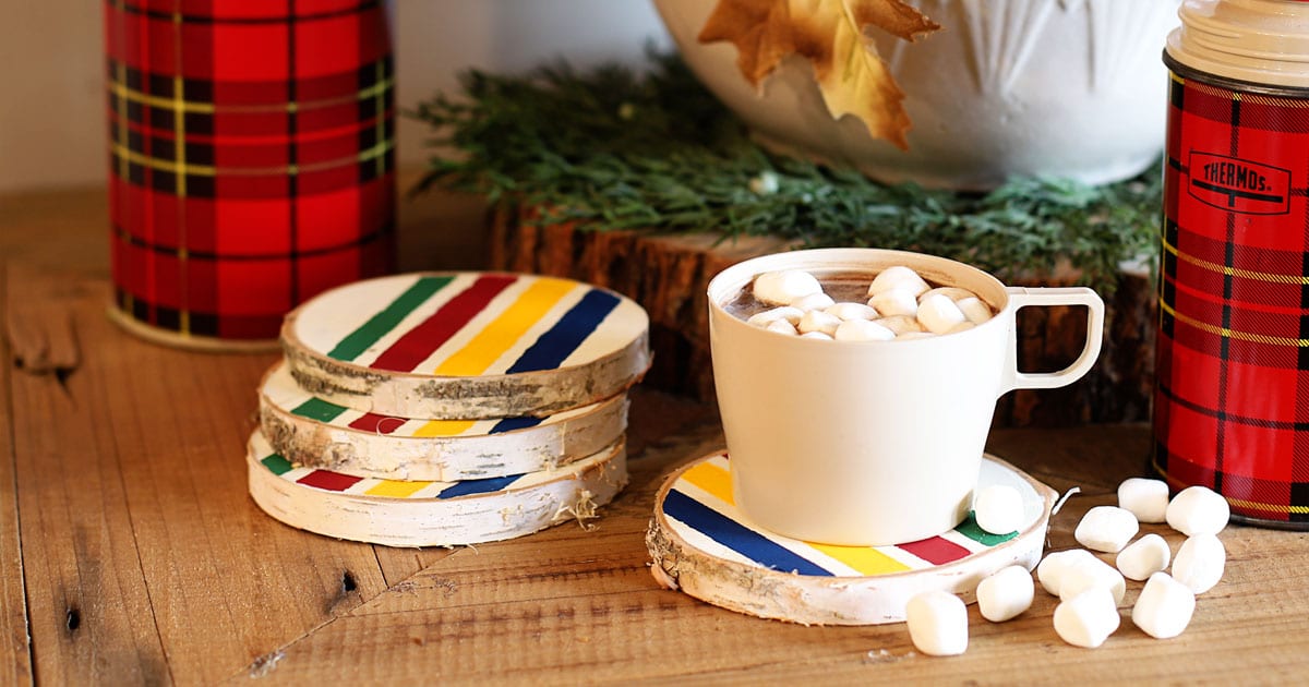 Hudson Bay blanket inspired coasters made from wood slices along with some classic plaid thermoses.