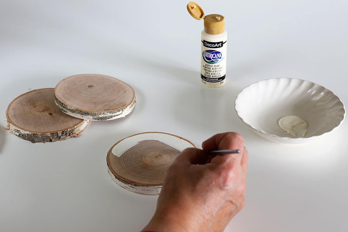 painting wooden slices used as coasters