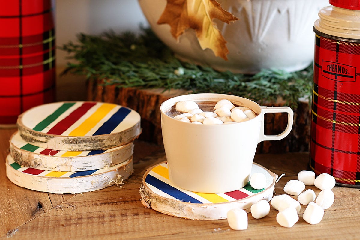 Hudson Bay blanket inspired coasters with a cup of cocoa and vintage red plaid thermoses