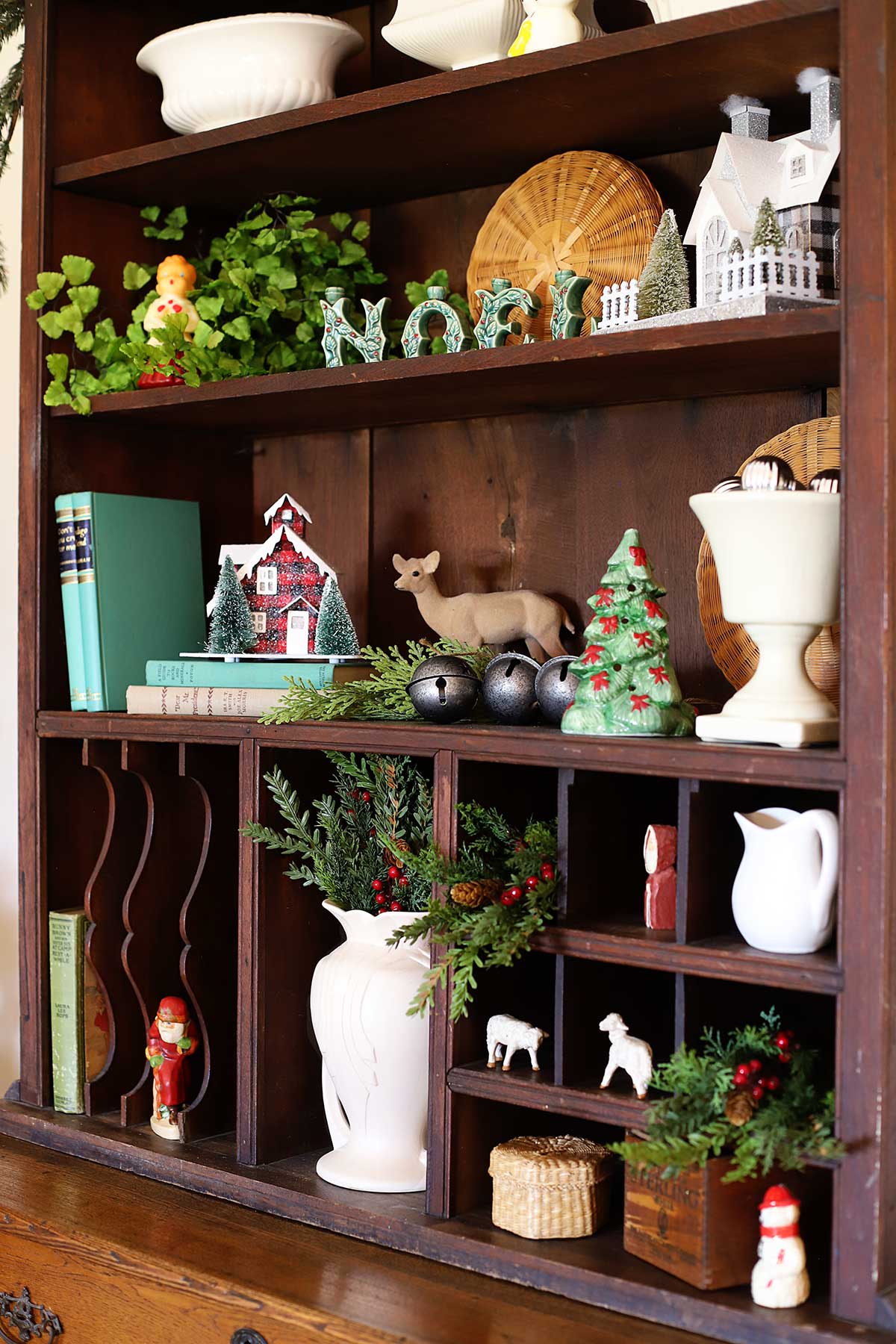 Vintage Christmas decor styled on a hutch.