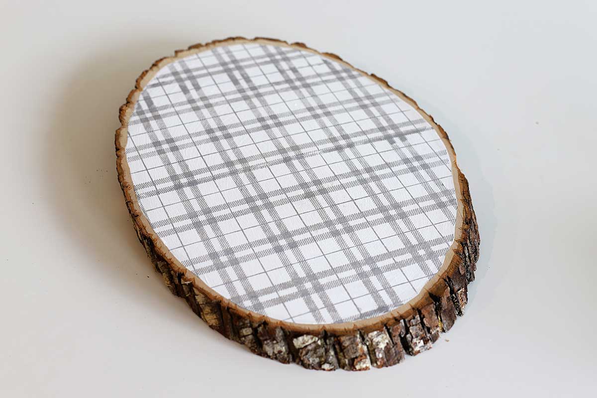 wood slice painted with gray plaid pattern