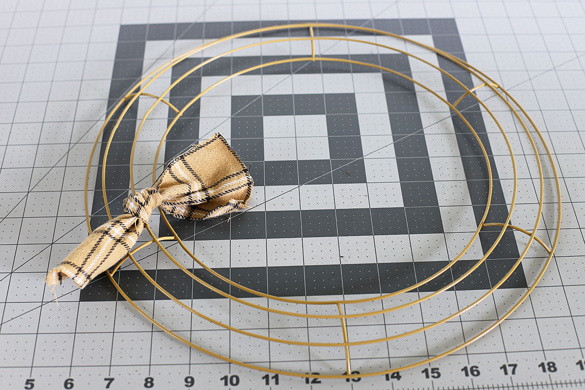 Tying flannel to a wreath frame.