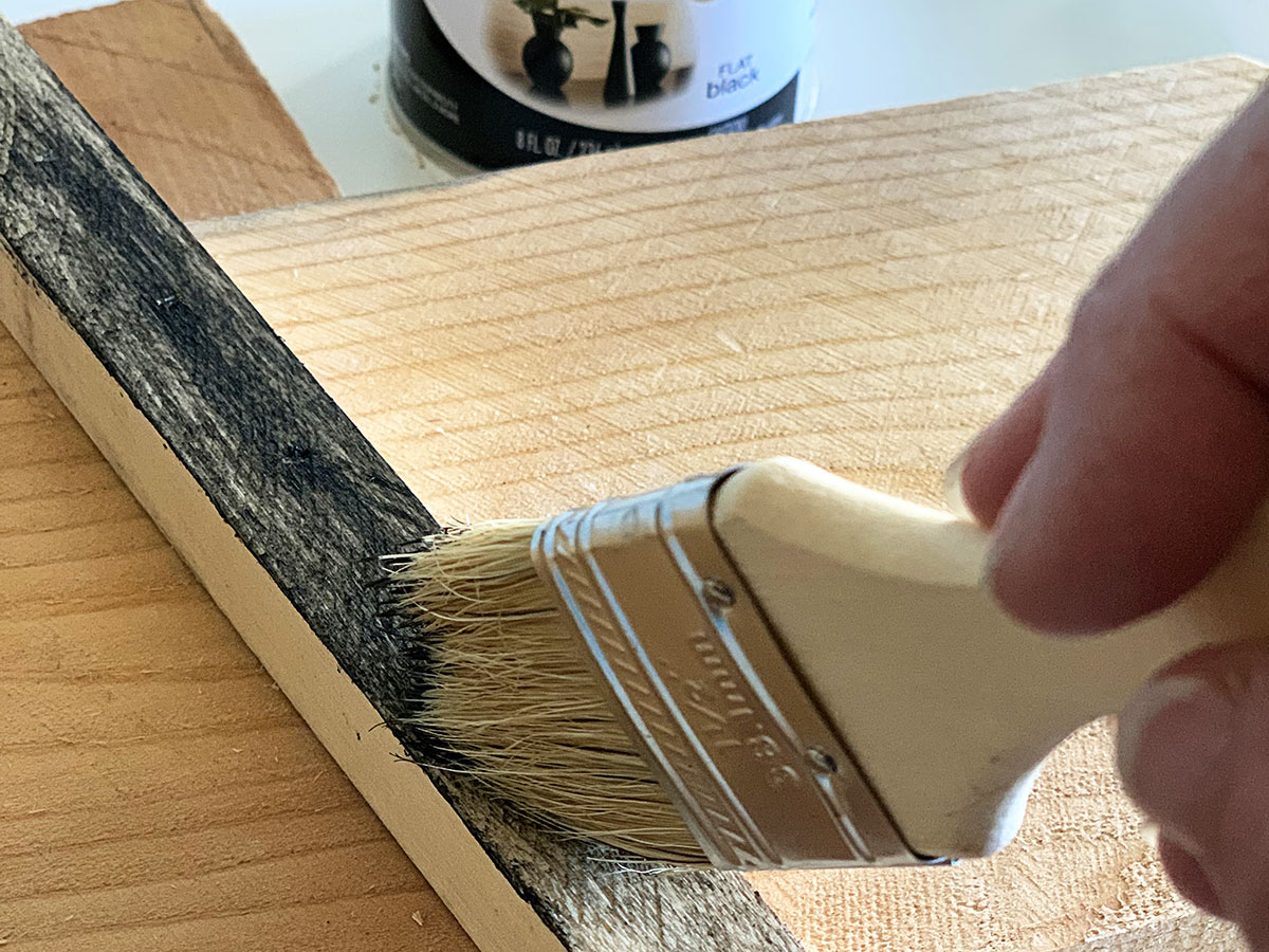 Using the dry brush method to paint the snowman's hat black.