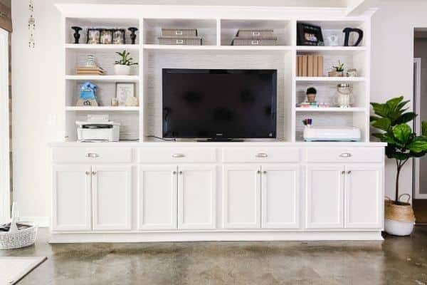 DIY white built in shelving unit made from cabinets from hardware store.