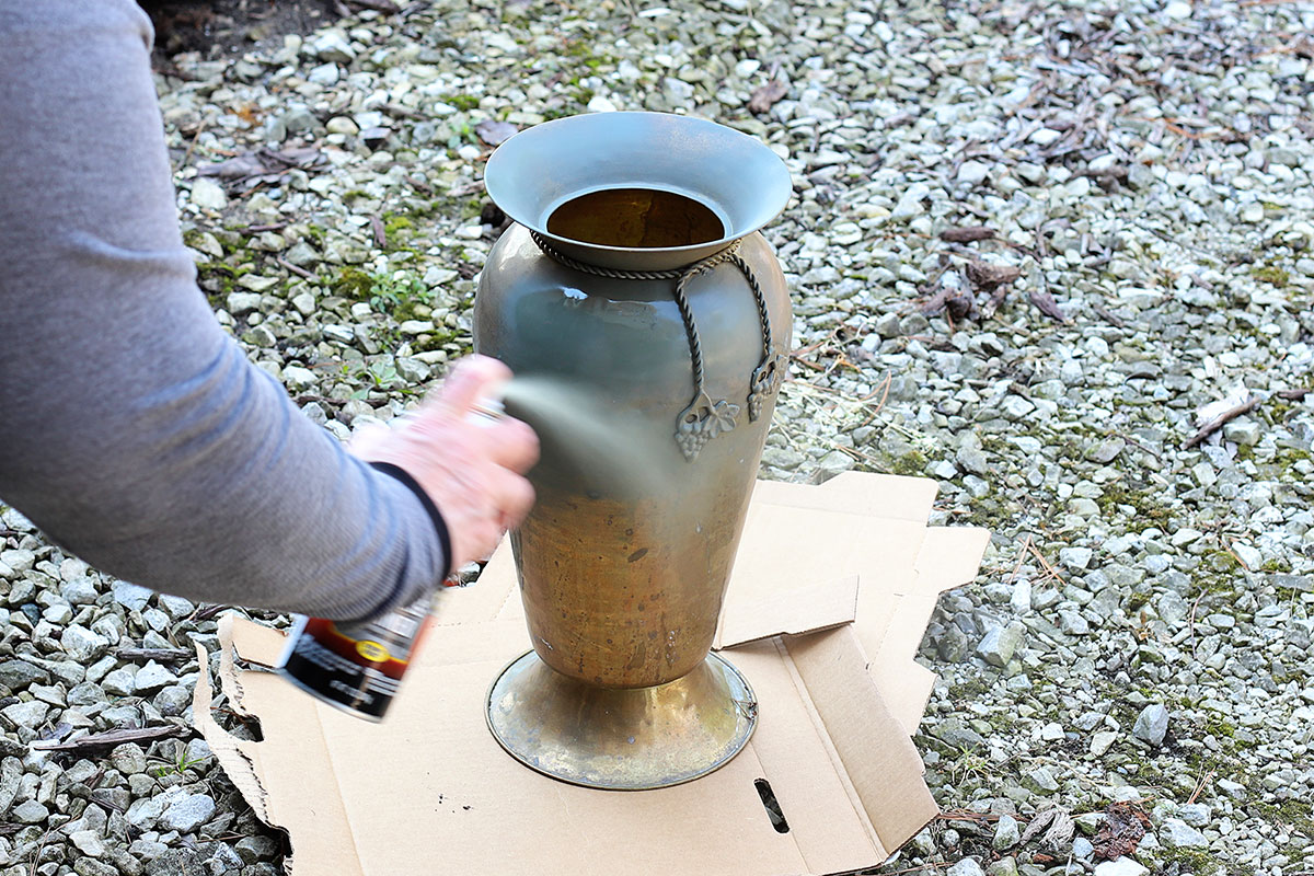 Applying Rustoleum Self Etching Primer to a brass urn.