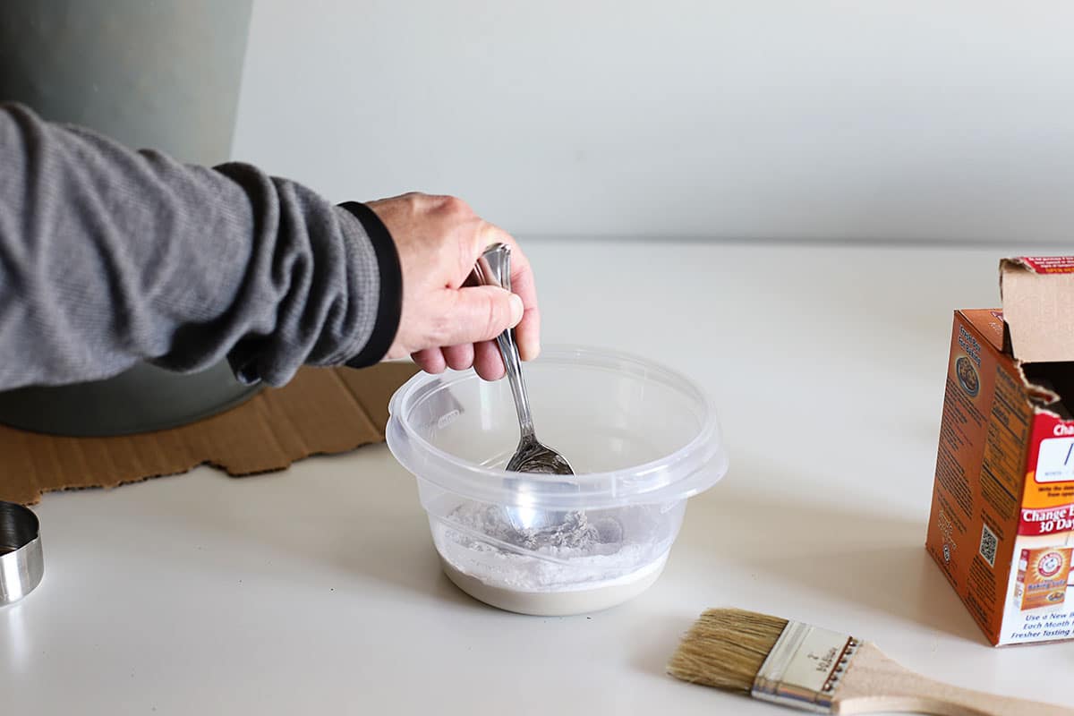 Mixing baking soda and paint together.