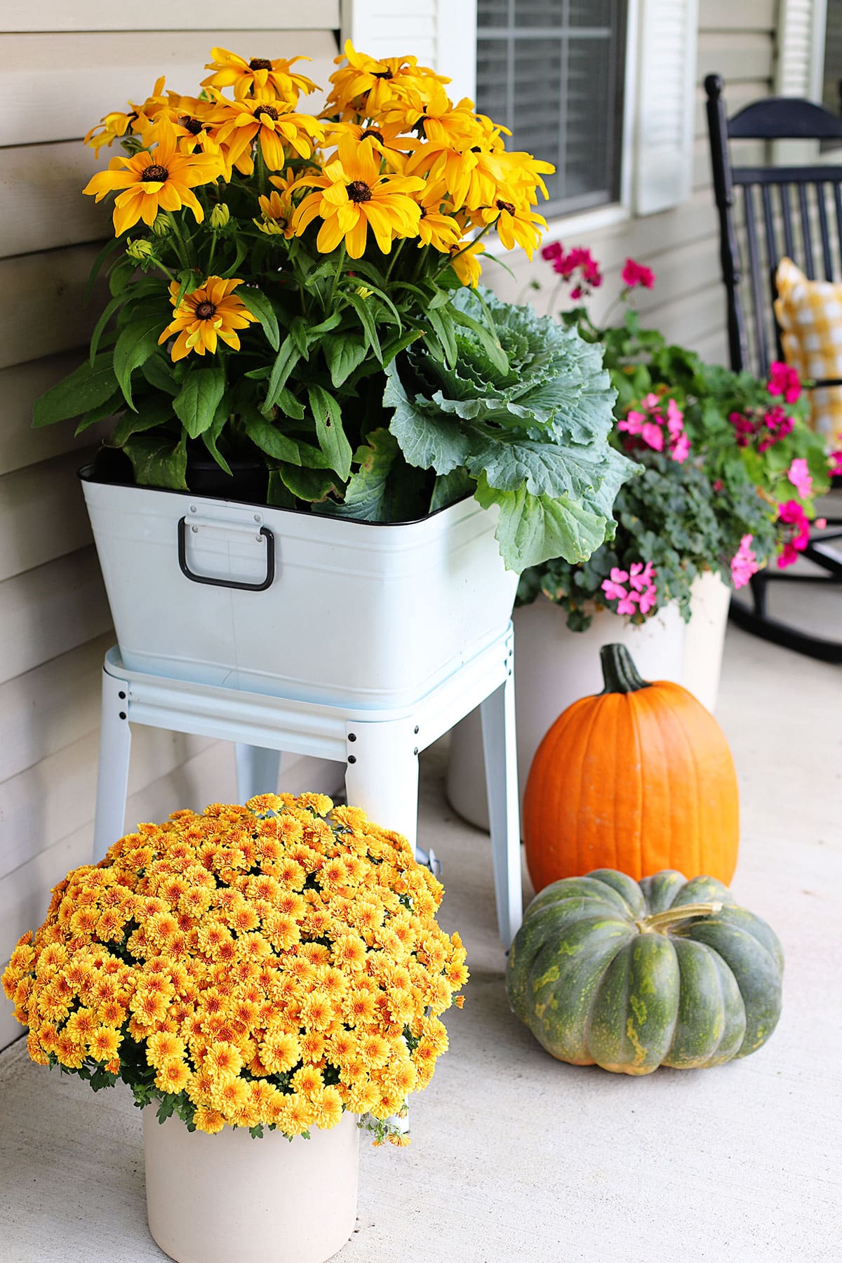 Black-eyed Susan, ornamental cabbage and croton planted in a enamelware wash tub on a fall front porch.
