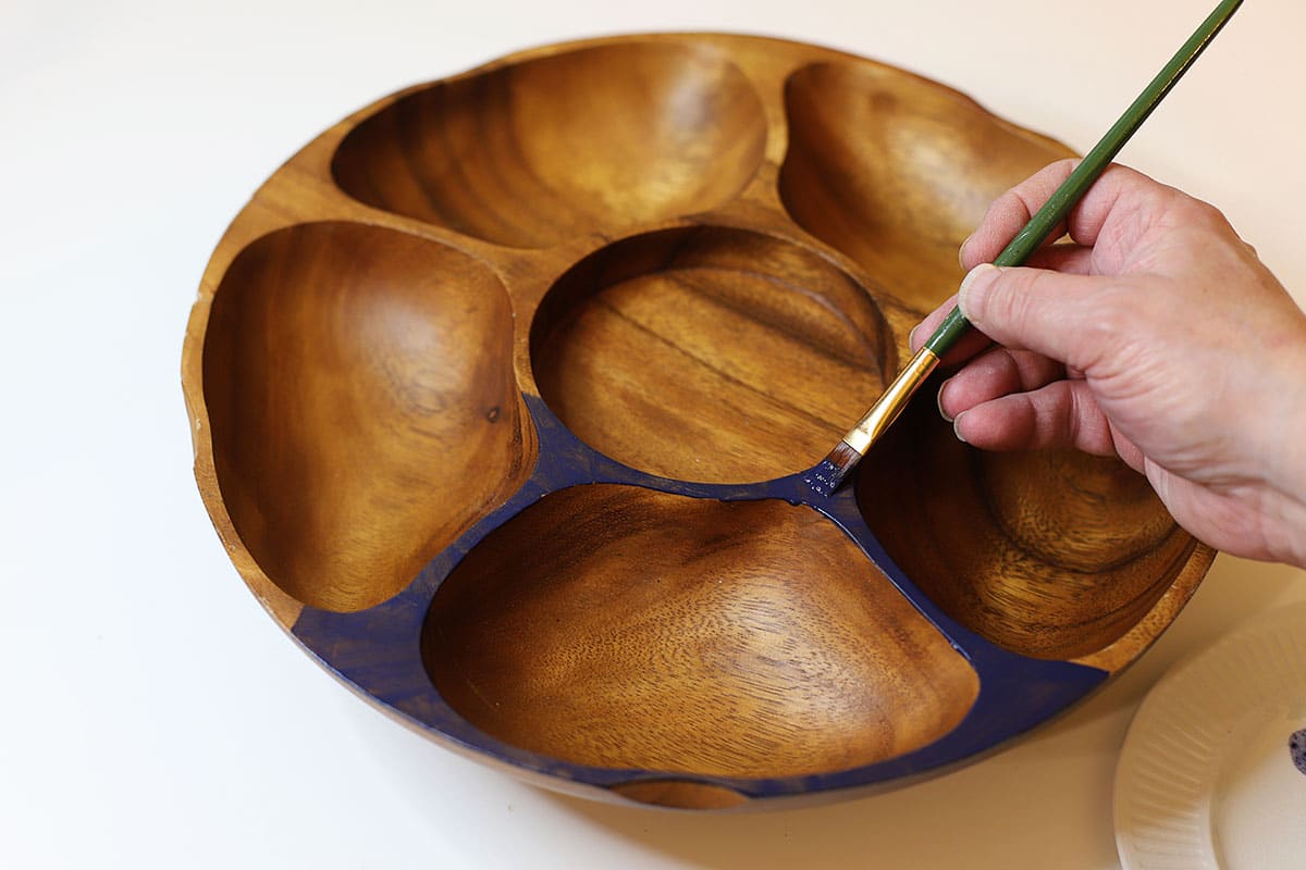 Painting a mid-century modern serving bowl with black craft paint.