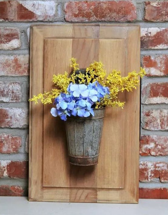 Repurposed cabinet door turned into flower holder.