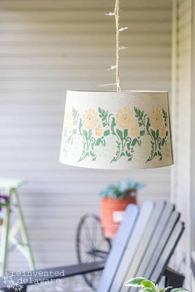 Stenciled lampshade used as lighting on a front porch.