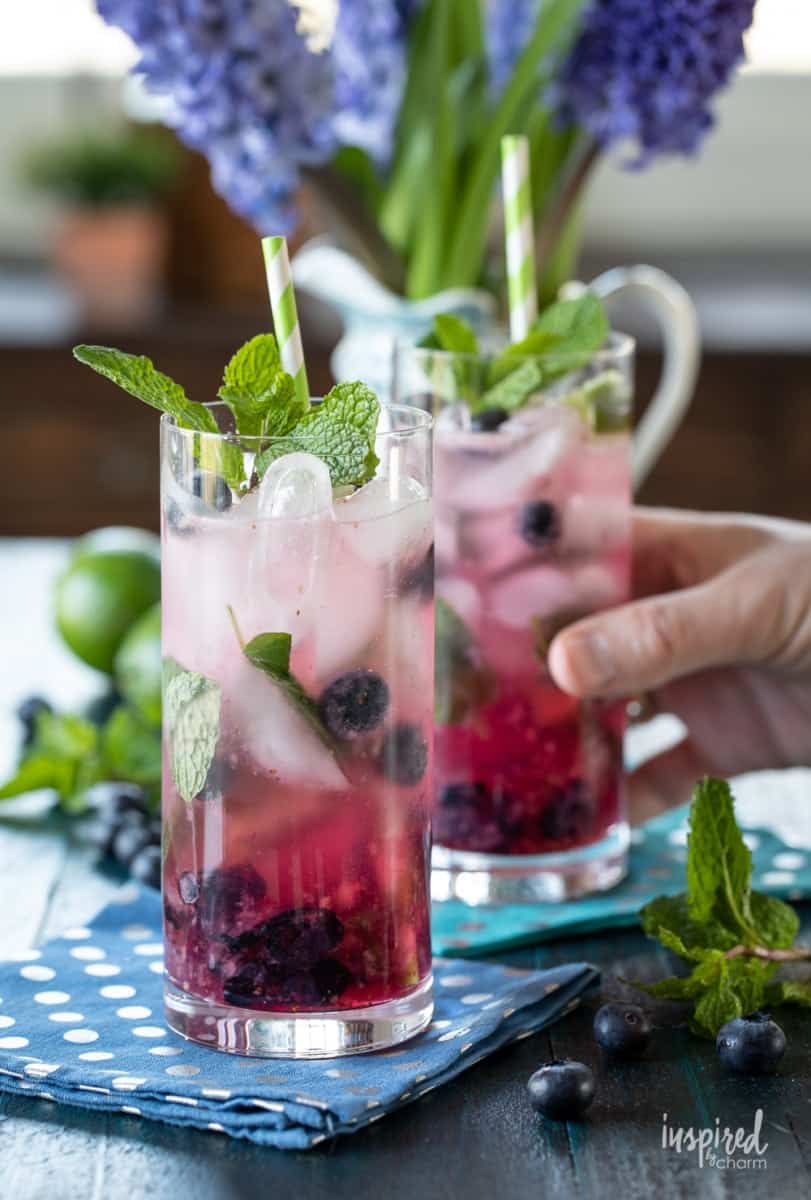 Summertime blueberry mojitos on a blue and white polka dot napkin.